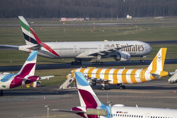 Düsseldorf Airport, Emirates Boeing 777 and Eurowings Airbus, Condor, aeroplanes on the apron,