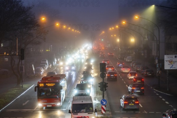 Dense fog, with visibility sometimes less than 100 metres, city centre traffic at rush hour on
