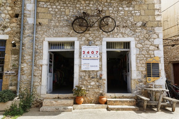 Facade with bicycle, outdoor activities, logo 2407, typical stone house in Stoupa, former fishing