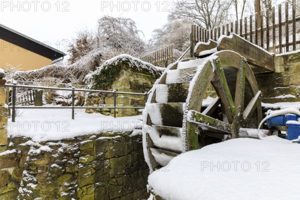 Small overshot waterwheel in the snow, Zschonermühle, Ockerwitz, Dresden, Saxony, Germany, Europe