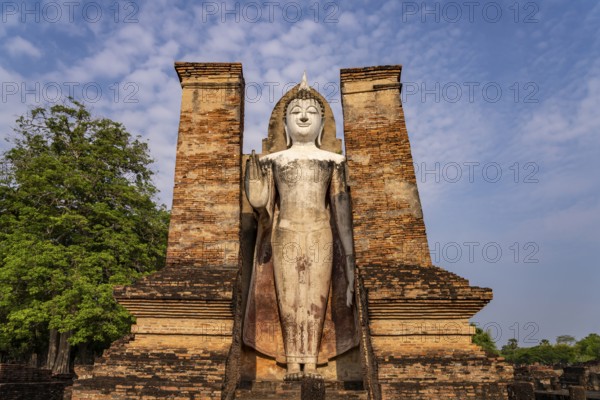 Giant standing Buddha in the Wat Mahathat temple in the UNESCO World Heritage Sukhothai Historical