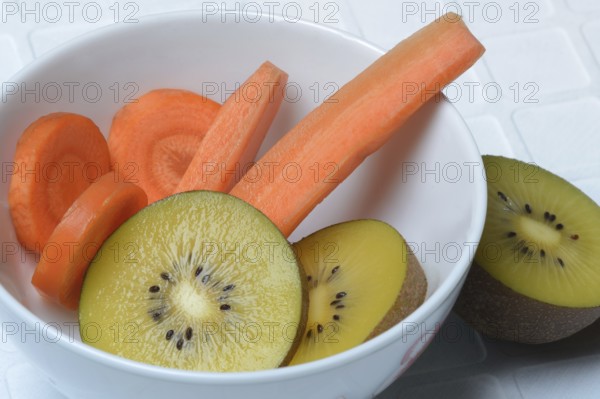 Sliced carrot and kiwi slices in peel, kiwi fruit and carrot