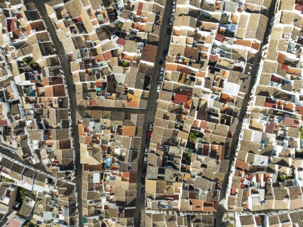 Streets and rooftops in the White Town of Olvera. Aerial view. Drone shot. Cádiz province,