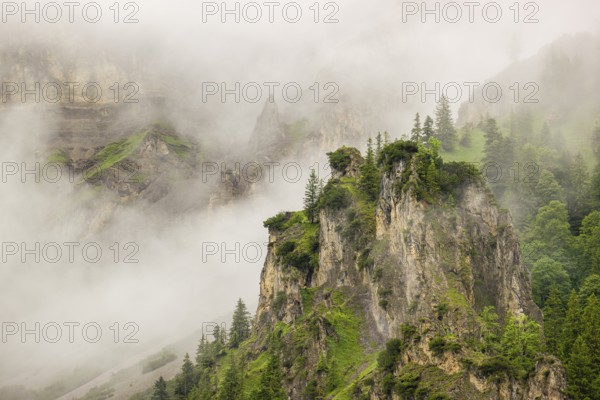 Wisps of mist cover the Karwendel mountains in the Großer Ahornboden nature reserve, Eng Valley,