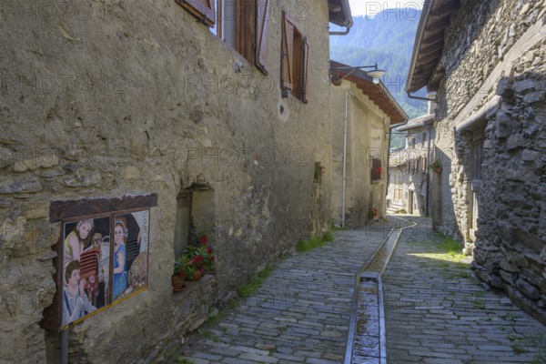 Pictures on the house walls characterise the narrow streets with old houses in the village,