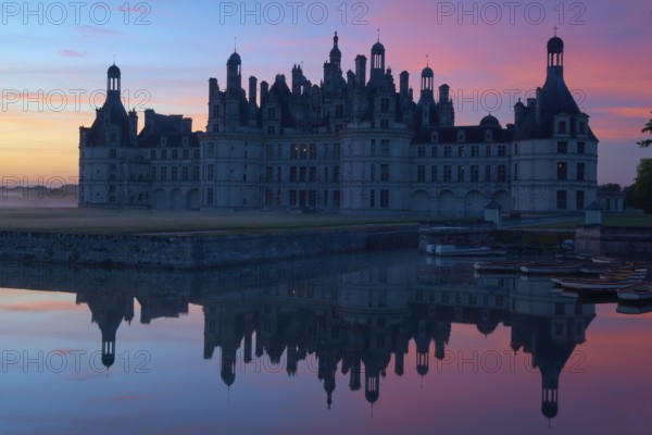 Chambord Castle with moat at sunrise, Chambord, Department Loir-et-Cher, Centre region, France,