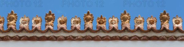 Close-up of a decorative roof ornament with ornate patterns under a blue sky, Poros, Poros Island,