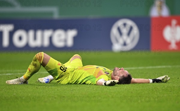 Goalkeeper Christian Mathenia 1. FC Nürnberg FCN (24) lies disappointed on the groundDFB-Pokal,