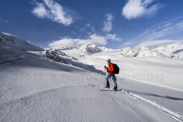 Ski tourers in a snow-covered mountain landscape, mountain peak Monte Cevedale and glacier
