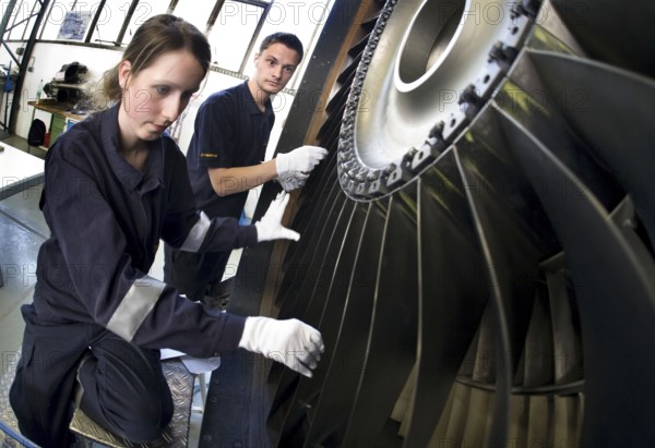 Trainees in the training workshop of Trainico, training as aircraft mechanics on a jet engine,