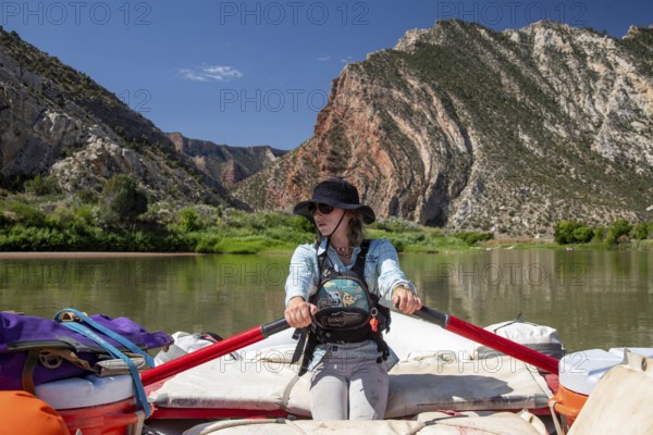 Dinosaur, Colorado, River guide Abbey Woodruff rows her raft on the Green River in Dinosaur