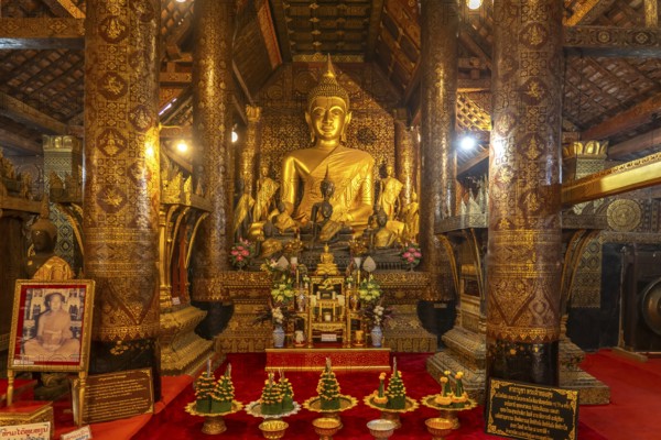 Buddha statue in the interior of the Buddhist temple Wat Xieng Thong in Luang Prabang, Laos, Asia