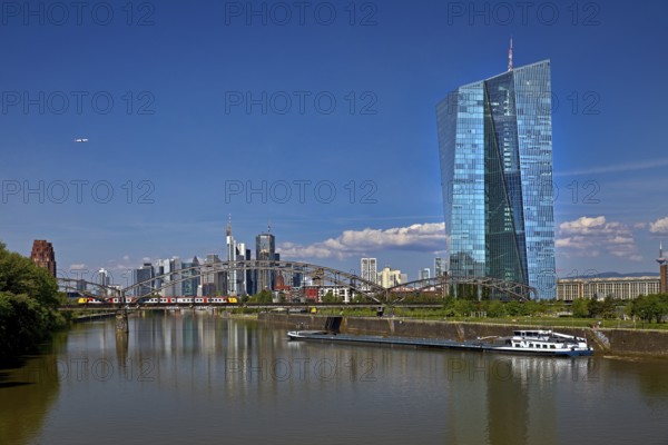 ECB European Central Bank with cargo ship on the river Main and the skyline of Frankfurt am Main,