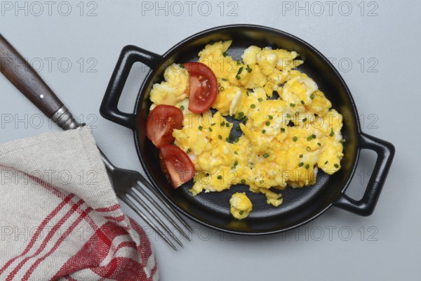 Scrambled eggs with tomatoes in a pan
