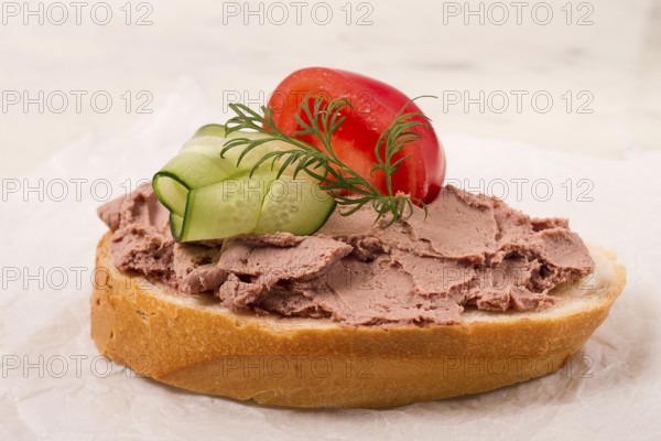 Liver meat pate spread, on white bread, on a light background, breakfast, close-up, no people,