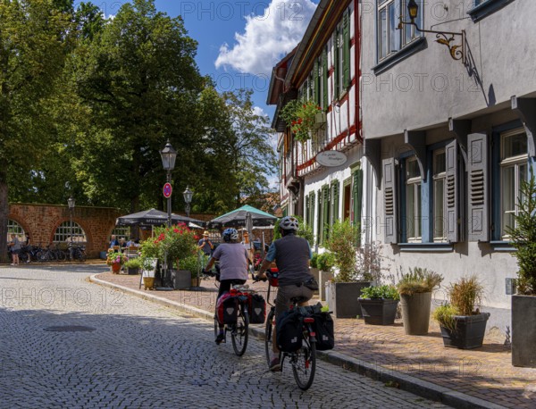 Cyclist in the old town centre, Seligenstadt, Hesse, Germany, Europe