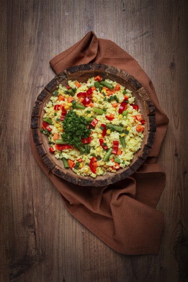 Couscous with vegetables, paprika, carrots, string beans, corn, homemade, top view, no people
