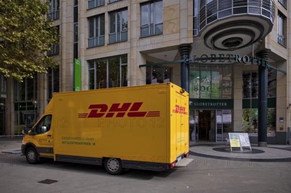 DHL delivery vehicle, logo, delivery, parked in front of Globetrotter department stores' chain,