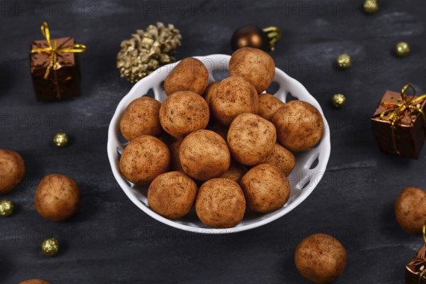 Traditional German Christmas sweets called Marzipankartoffeln. Round ball shaped almond paste
