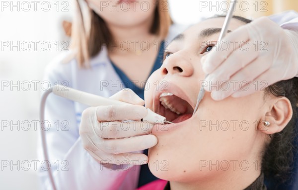 Patient checked by dentist, Dentist doing dental checkup, Close up of dentist checking patient with