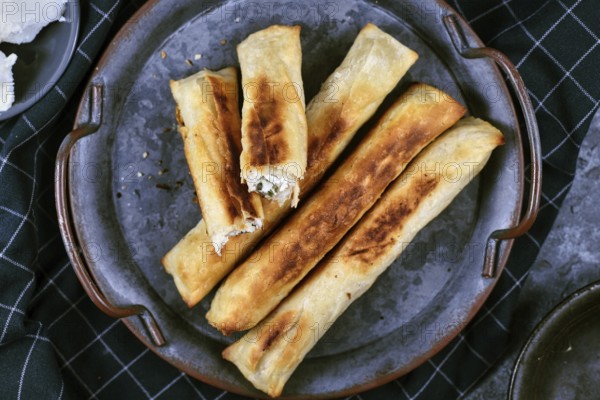Fresh baked Börek, a baked filled pastries made of a thin flaky dough filled with sheep milk cheese