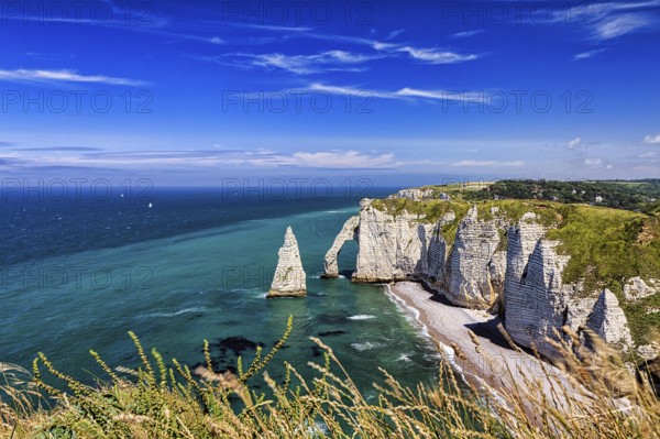 View from above of striking chalk cliffs, rock arch Porte dAval and rock needle Aiguille, Etretat,