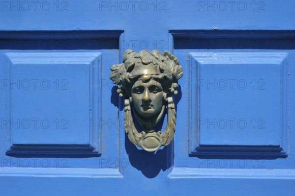Head shaped door knocker on a blue door, Mykonos Town or Chora, Mykonos, Cyclades, Greece, Europe