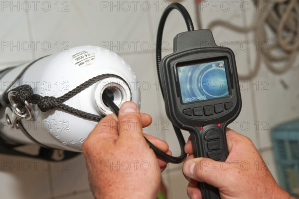 Checking visual inspection with mini camera and display of inside of gas pressure tank diving