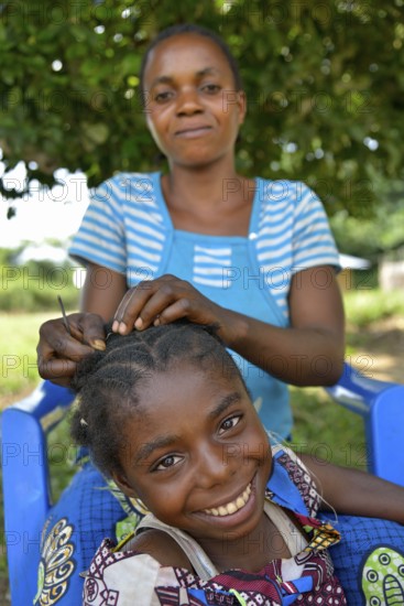 Mother doing her daughter's hair, Nkala, Bandundu Province, Democratic Republic of the Congo