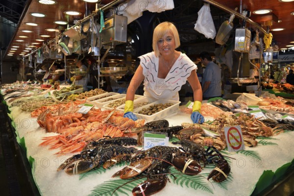 Fishmonger at her stall in the market hall, Mercat de la Boquería, also Mercat de Sant Josep,