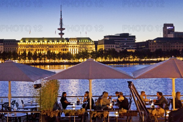 People on the restaurant ship Bootshaus Alster on the Inner Alster Lake in the evening, Hamburg,