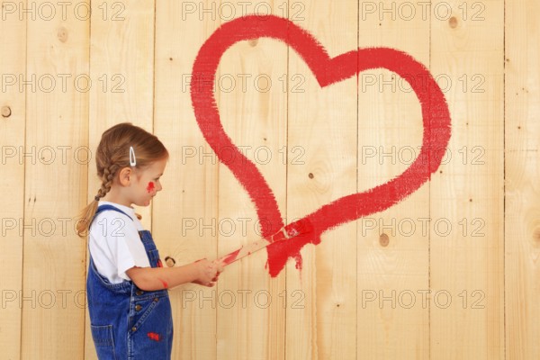 Girl paints, paints heart, with brush, Mother's Day