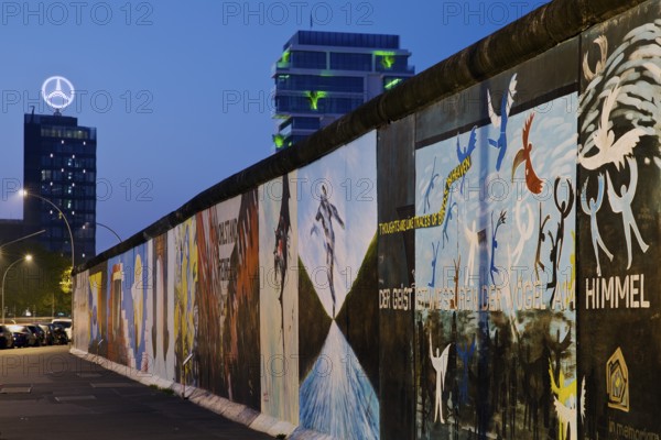 Mural on the Berlin Wall with Mercedes star, Berlin, Germany, East Side Gallery in the blue hour,