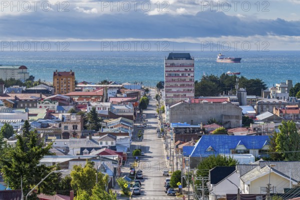View from a hill over streets and houses to the Strait of Magellan, city of Punta Arenas,