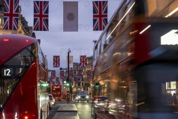 Red double-decker buses, English flags, evening mood, Oxford Circus, London, London region,