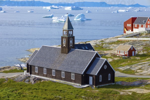Typical architecture of Greenland Ilulissat with colored houses located near fjords and icebergs