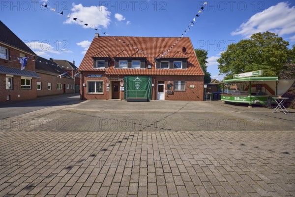 Old inn Kentrup and beer wagon with decorated fairground for the shooting festival in Buldern,