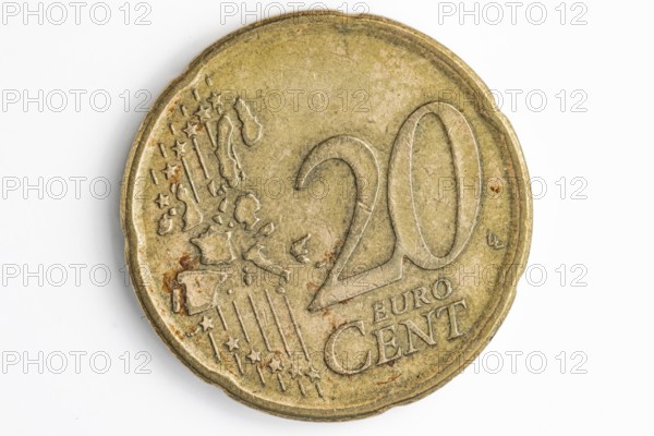 Close-up of the front of a used 20 cent coin, white background