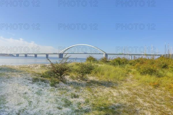 Beach in front of Fehmarnsund Bridge, connects the island of Fehmarn in the Baltic Sea with the