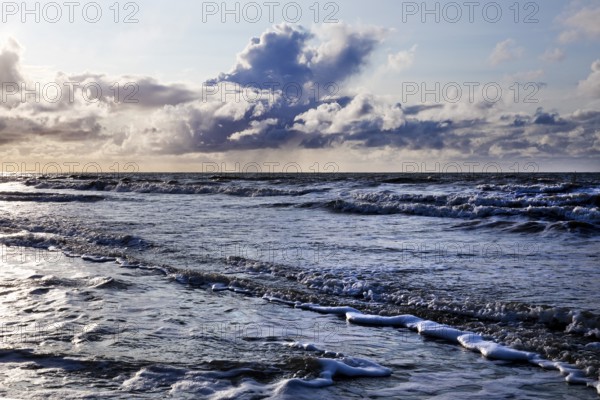 Outgoing tidal fringe in the mudflat landscape with dramatic clouds, North Sea, Norderney Island,
