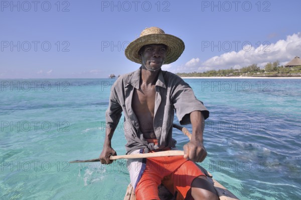 Local fisherman in his boat, Dongwe Beach, Dongwe, Zanzibar, Tanzania, Africa