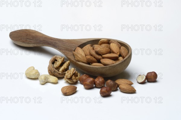 Wooden ladle with various nuts