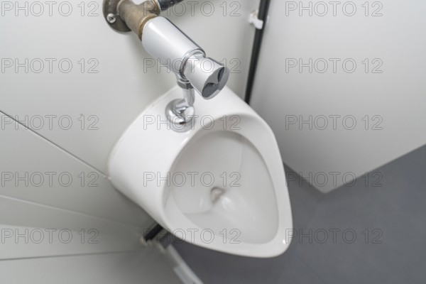 Close-up of a white urinal in a modern style, refugee accommodation Beermiß, Calmbach, Black