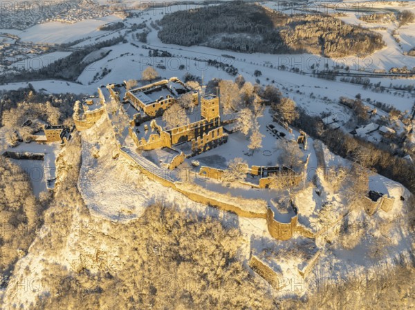Aerial view of the snow-covered Hegau volcano Hohentwiel with Germany's largest castle ruins on a