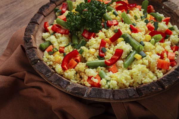 Couscous with vegetables, paprika, carrots, string beans, corn, homemade, top view, no people