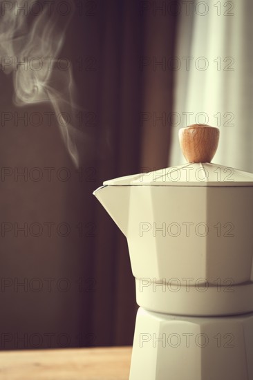 Geyser coffee maker, beige, close-up, boiling, steam from the spout, morning, breakfast, no people