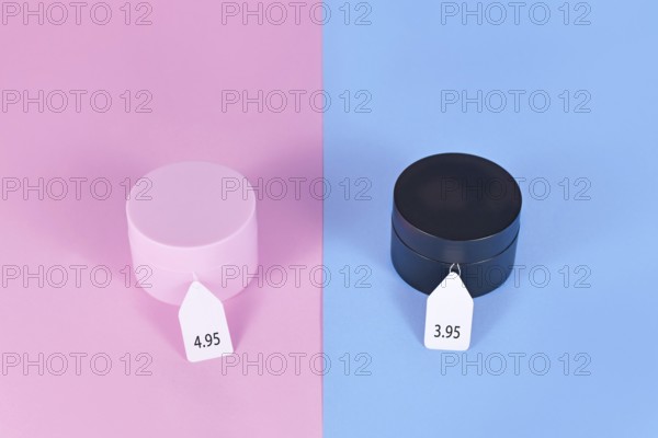 Pink tax concept showing pink and black facial cremes aimed at specific genders with different
