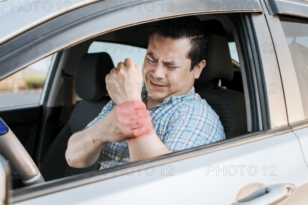 Driver suffering from wrist pain. Sore driver man touching his wrist. Driver with hand pain.