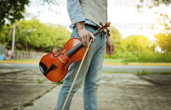 Hands holding violin and hoop outdoors, Close up of hands holding violin and hoop. Concept of