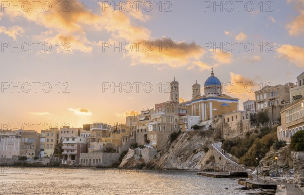 View of the village with the Greek Orthodox church of Agios Nikolaos, Asteria Beach, at sunset with